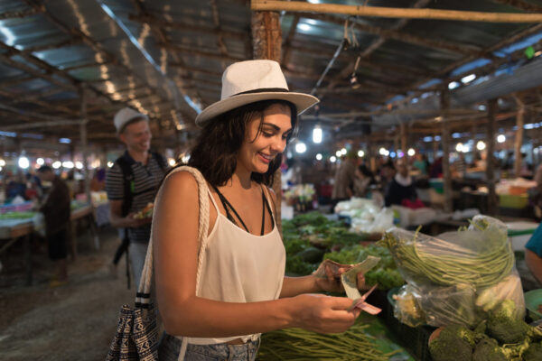 Young Woman Paying Money For Fresh Vegetables On Market Girl Shopping On Trational Street Bazaar